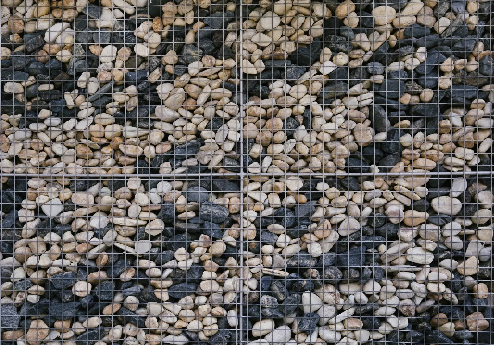 Gabion stone wall of mixed natural rocks