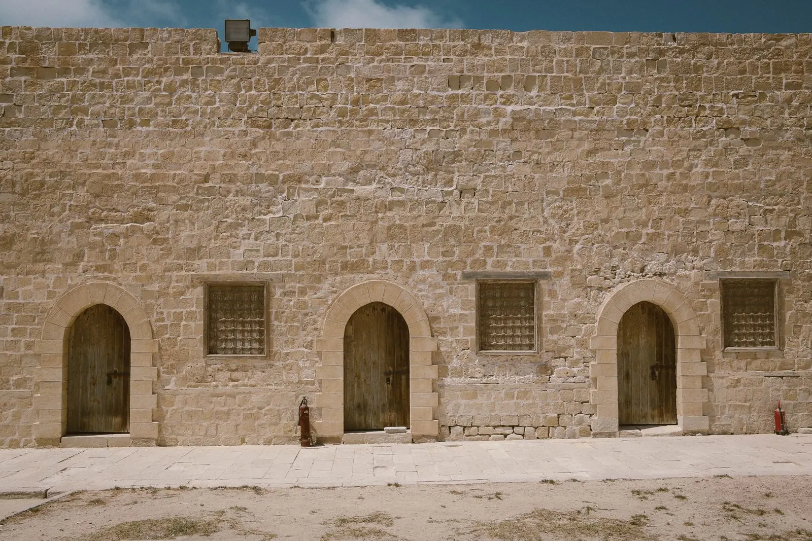 Stone building facade with arched entrances