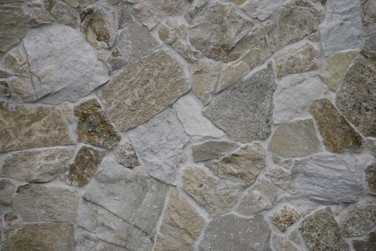 Close-up of a textured stone wall with natural patterns