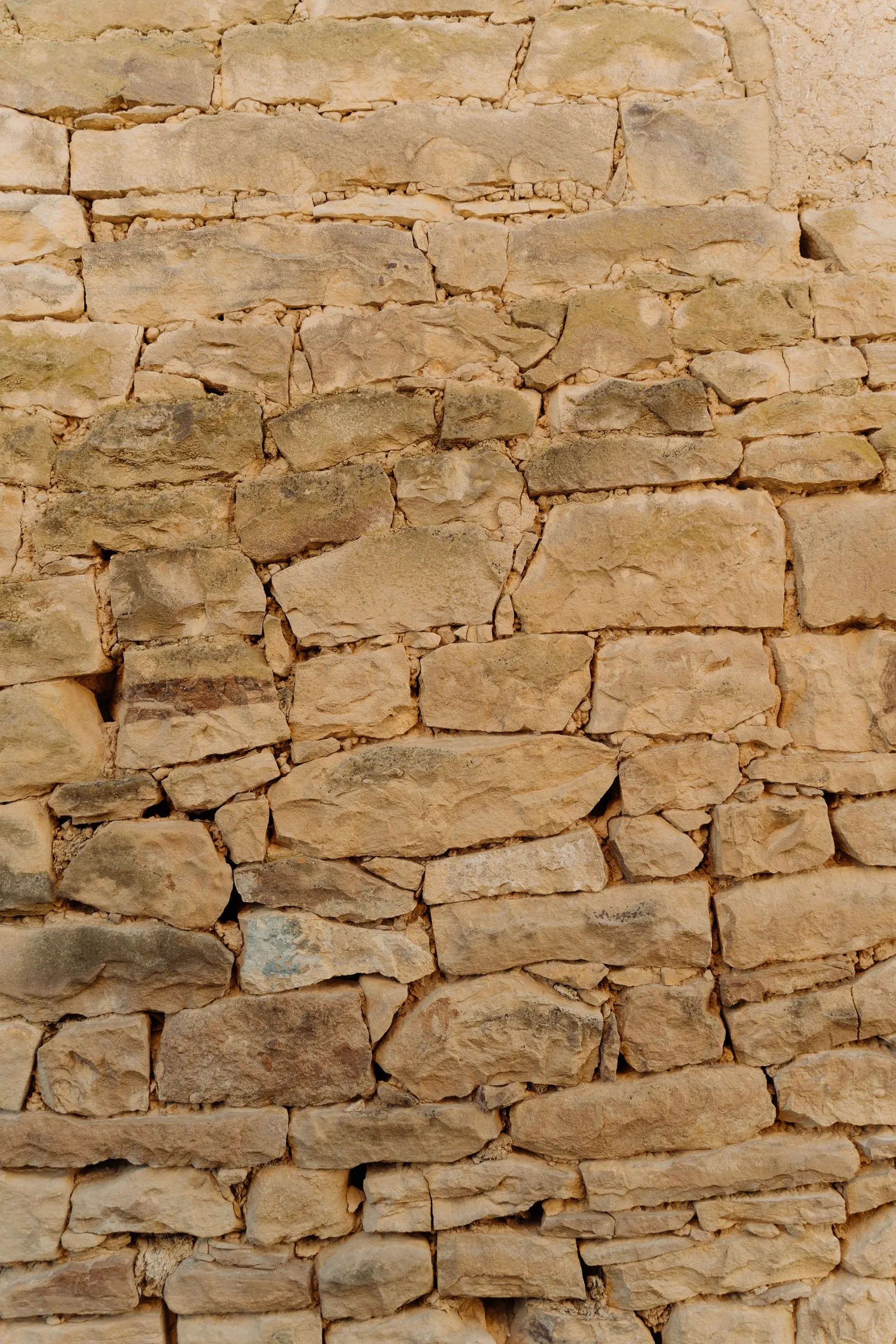 Close-up of a rustic natural stone wall texture
